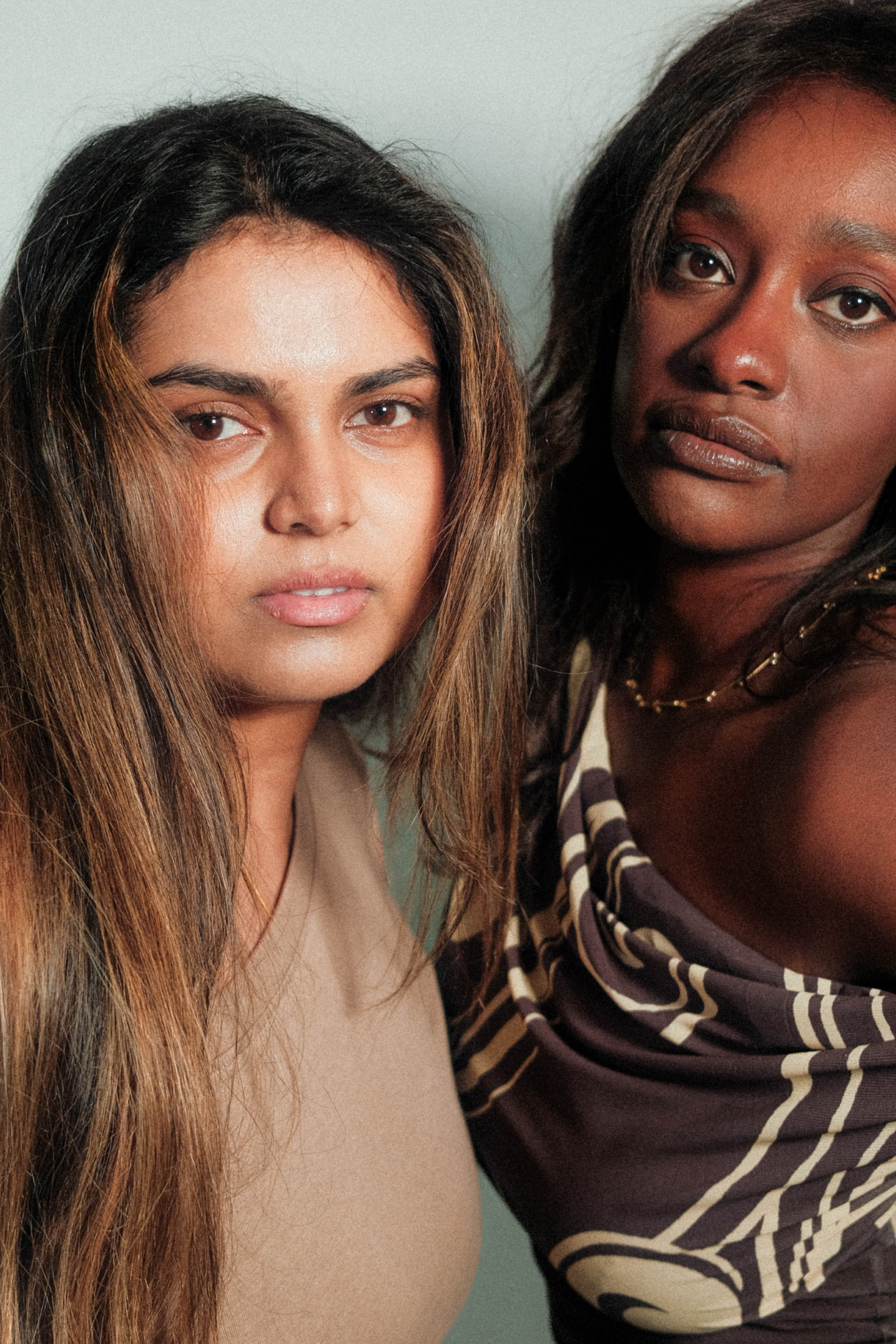 Close portrait of Shalom and Nithya, Monnaro co-founders, looking towards the camera